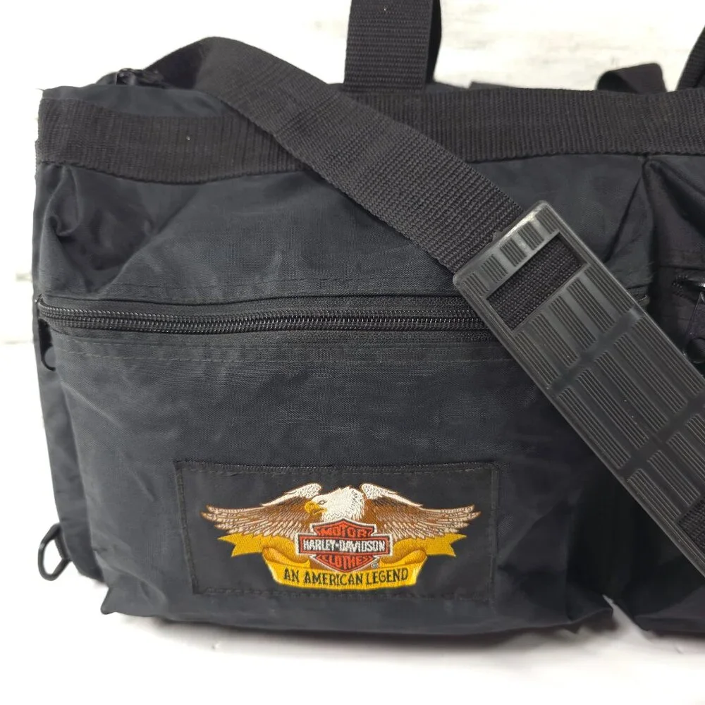 VINTAGE HARLEY DAVIDSON AN AMERICAN LEGEND BLACK DUFFLE BAG WITH SHOULDER STRAP.